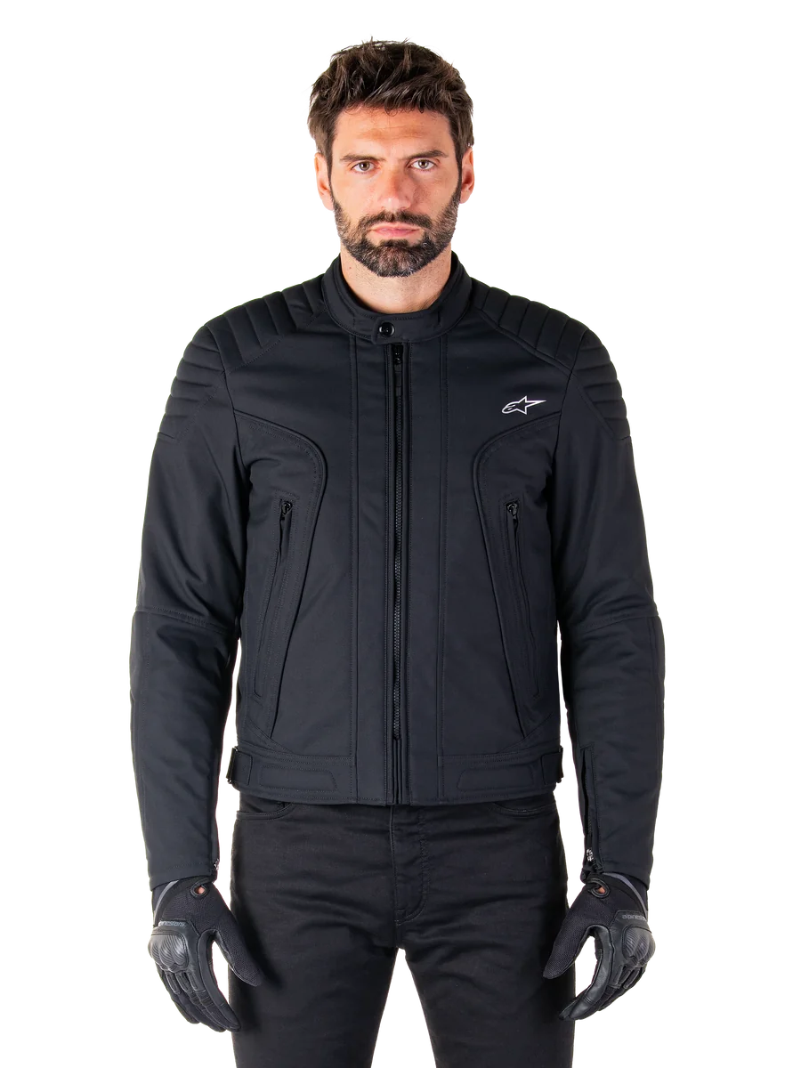 Alpinestars Clayton WR Jacket, Black Motorcycle Jacket, worn by model, featuring quilted shoulder details and technical graphics, central Vislon zipper, vertical zippered pockets, small white logo on chest, urban riding gear for road use