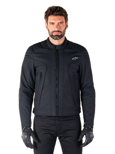 Alpinestars Clayton WR Jacket, Black Motorcycle Jacket, worn by model, featuring quilted shoulder details and technical graphics, central Vislon zipper, vertical zippered pockets, small white logo on chest, urban riding gear for road use