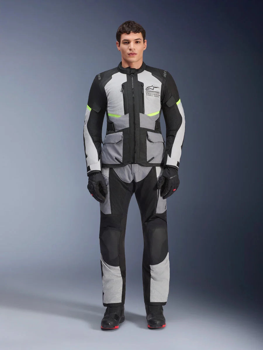 Alpinestars Andes Air Drystar® Pants, Adventure Touring Motorcycle Pants, Ice Gray and Black with neon yellow accents, full-body view on a model wearing the matching jacket and gloves, textile design with mesh ventilation panels