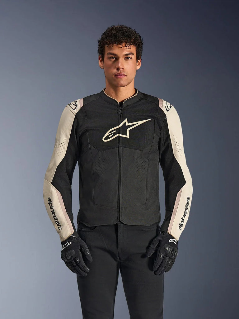 Alpinestars T-SPS Air V2 Jacket, Motorcycle Riding Jacket, Black and Mastic Aluminum, male model wearing jacket with black pants and gloves, featuring mesh panels for ventilation, large Alpinestars logo on the chest, and sporty fitted design
