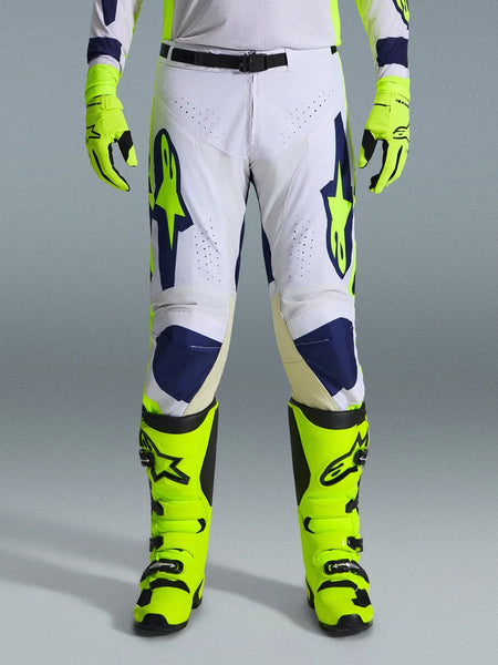 Alpinestars 2026 Racer Air Riway Pants, Motocross Pants, Light Gray Yellow Fluo and Blue, worn with matching neon yellow gloves and boots, featuring perforated front panels for airflow and bold blue and yellow branding, athletic design for off-road performance