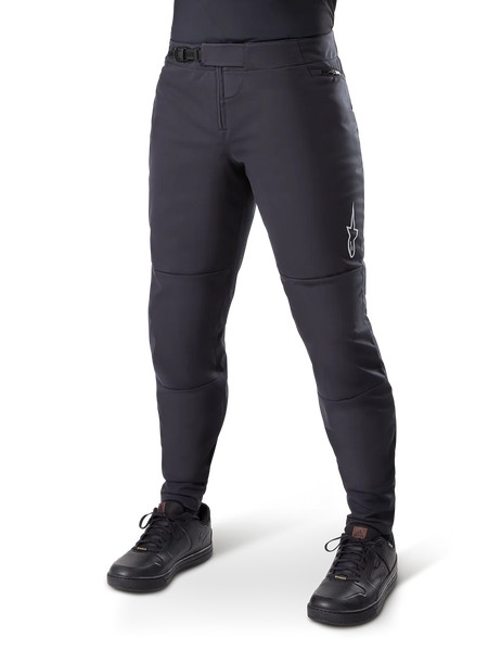 Alpinestars A-Dura Thermal Pant, Black Mountain Bike Pants, worn with black cycling shoes, featuring a ratchet waist closure, small white logo on the thigh, tapered fit for cold-weather riding