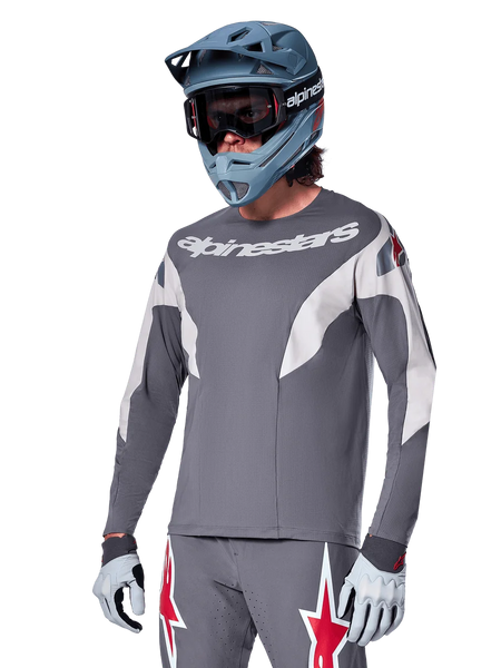 Alpinestars A-Supra Race Jersey - Long Sleeve, Dark Gray with white and red accents, racing-style graphics, worn with matching gray pants, blue full-face helmet, and white gloves, professional MTB and downhill racing gear