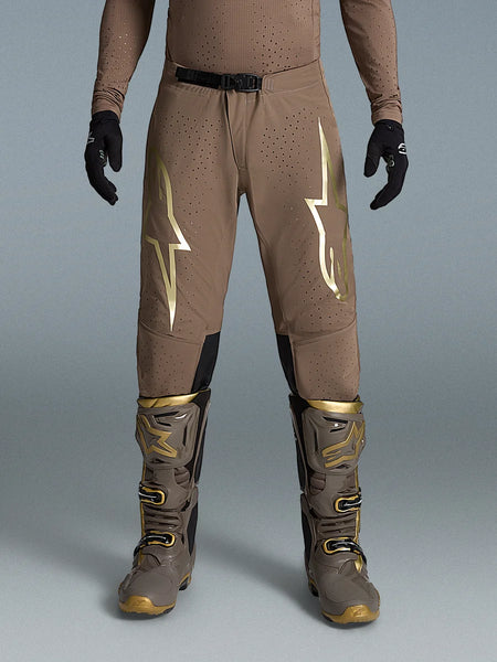 Alpinestars Limited Edition Supertech Air Gold Pants, Brown and Gold Motocross Gear on-model with Tech 10 boots.
