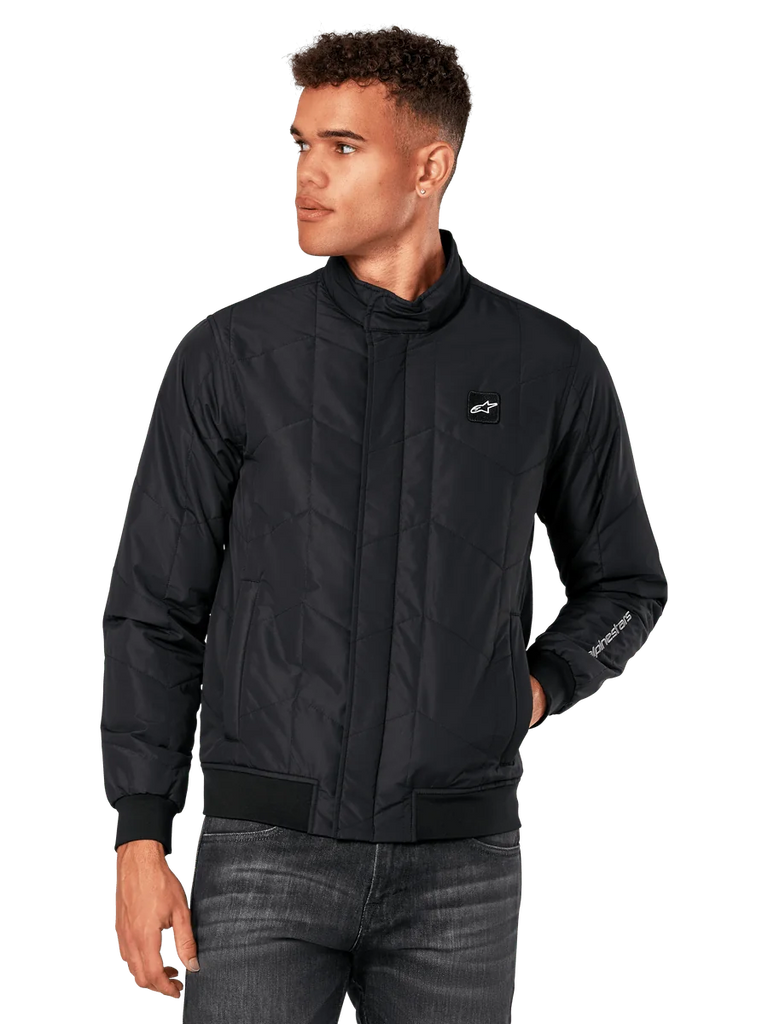 Alpinestars Precedent Jacket, Black Quilted Jacket with angled pattern, Formula 1 styling, low track collar, ribbed cuffs and hem, chest logo patch, sleeve embroidery, motorsport-inspired lifestyle streetwear