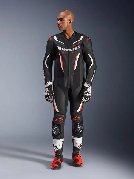Alpinestars GP Force V2 Leather Suit - 1Piece, Black White and Red Fluo, full-body view of male model wearing professional motorcycle racing gear with matching gloves and boots, featuring perforated leather panels and protective knee sliders.