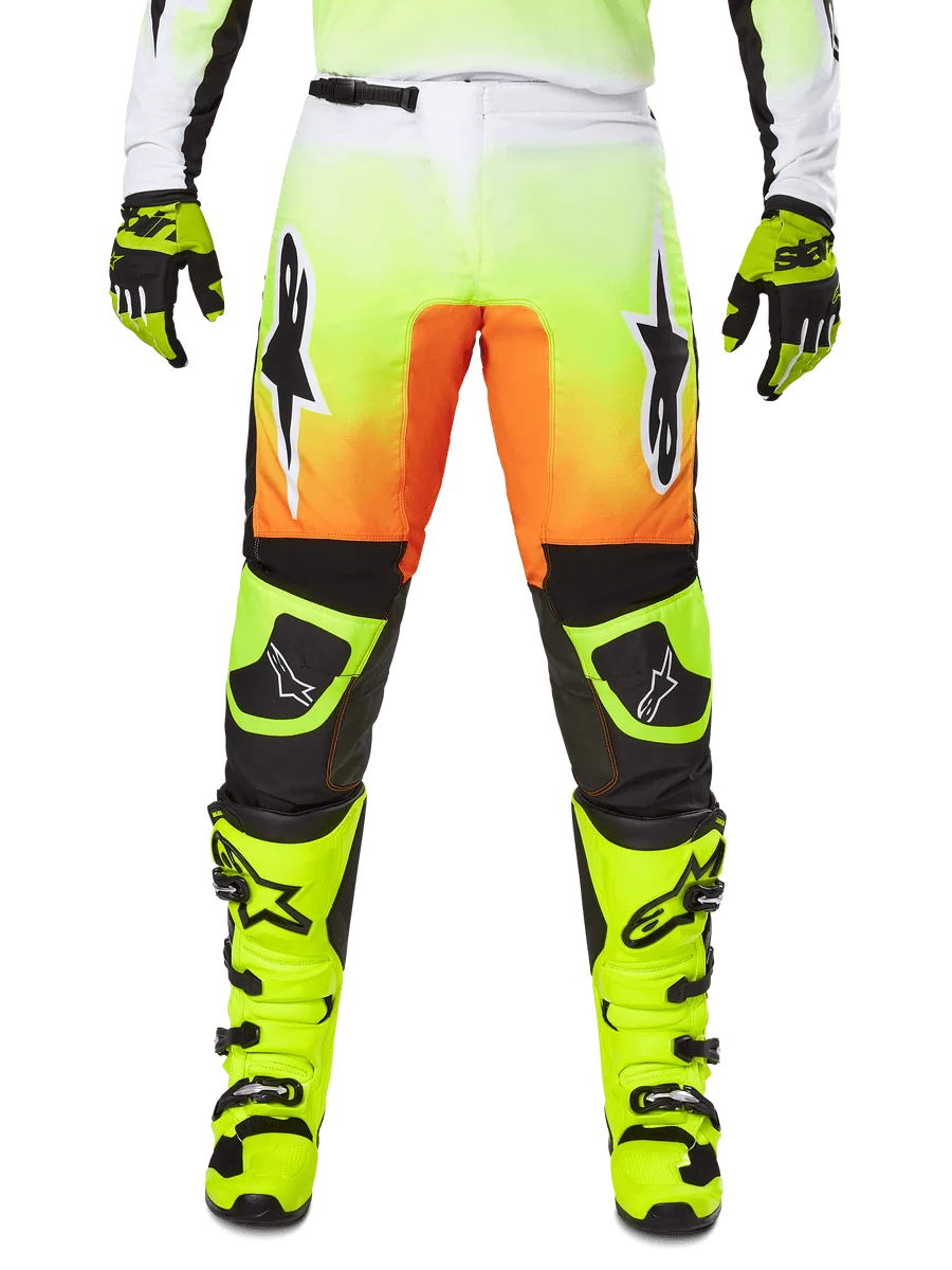 Alpinestars 2025 Fluid Wurx Pants, Motocross Pants, Neon Yellow and Orange, Black and White Star Logos, Sleek Racing Design with Black Knee Sections, coordinated with matching neon yellow boots and gloves