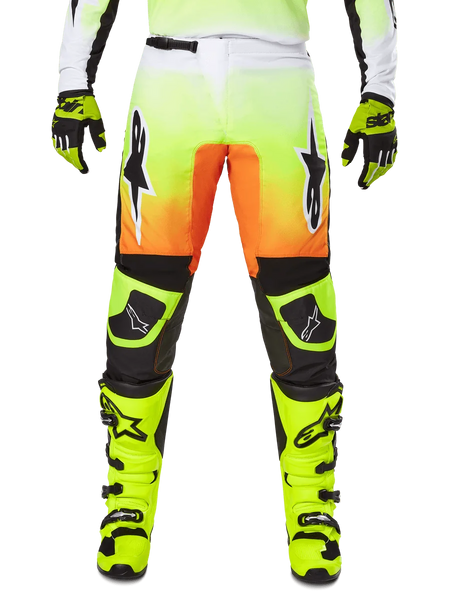 Alpinestars 2025 Fluid Wurx Pants, Motocross Pants, Neon Yellow and Orange, Black and White Star Logos, Sleek Racing Design with Black Knee Sections, coordinated with matching neon yellow boots and gloves