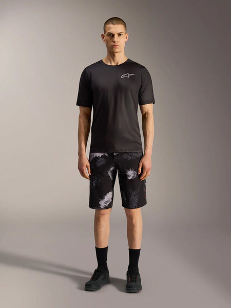 Alpinestars A-Dura Ride Shorts in Black Camo, styled with a black performance tee for mountain bike versatility.