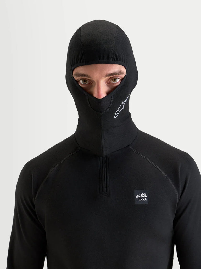 Alpinestars AT-8 Merino Balaclava, motorcycle and all-terrain adventure balaclava, black, worn by a model showing merino-blend thermal regulation and under-helmet comfort