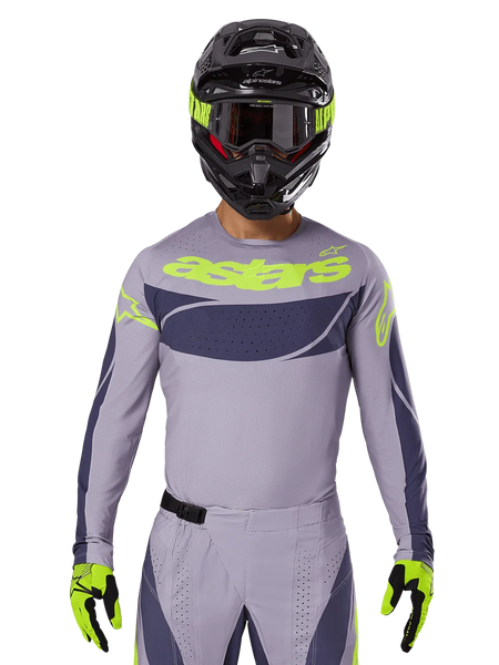 2025 Techstar Dreem Jersey and Gear Set, Motocross racing outfit, light gray and dark gray with neon yellow accents, features 'astars' branding, worn with black helmet, goggles, and matching gloves, technical perforated material for off-road performance