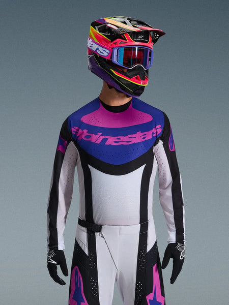 Alpinestars 2026 Techstar Knif Jersey, Motocross Jersey, Black Light Gray and Purple, pink Alpinestars logo on the chest, worn with matching colorful helmet and motocross pants, athletic race fit with laser-cut perforations for ventilation