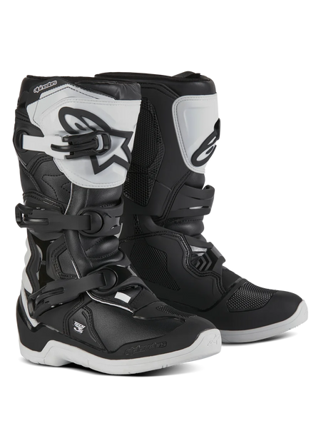 Alpinestars Youth Tech 3S Boots, Motocross Boots for young riders, Black and White, featuring three adjustable buckle straps, white TPU shin plate with Alpinestars logo, reinforced hard shell protection, and a sturdy white treaded sole, off-road racing design