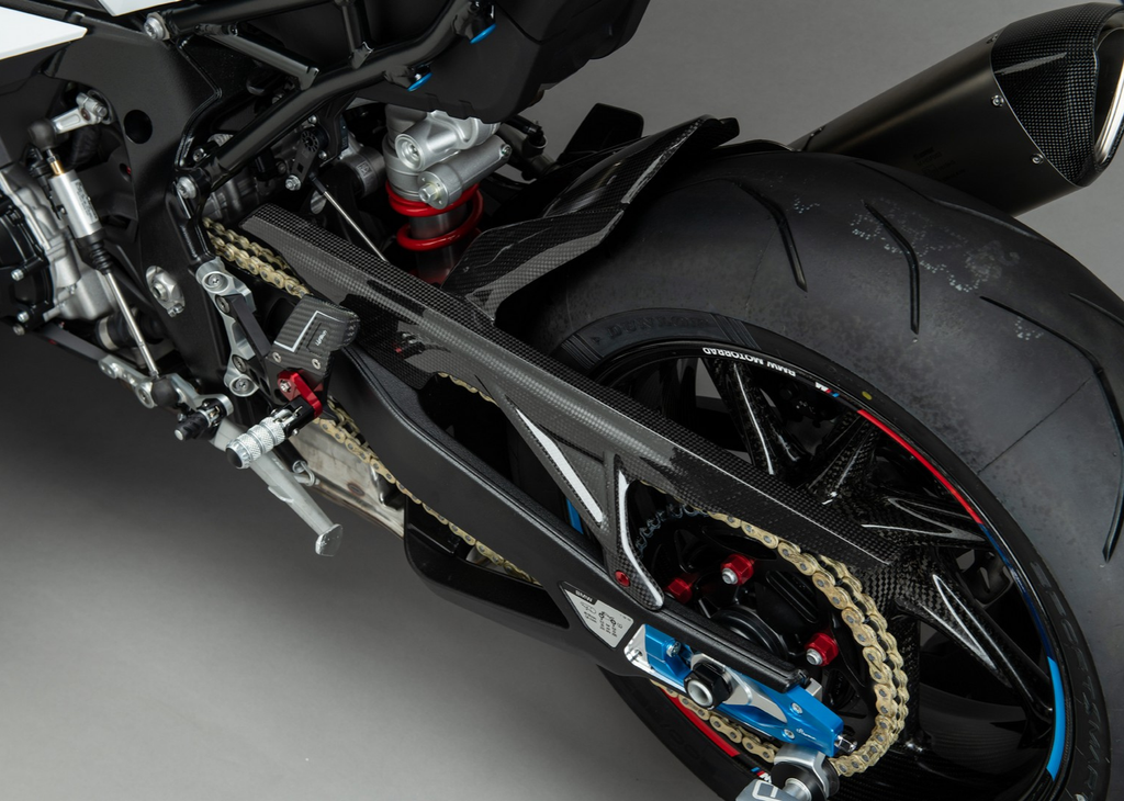 LighTech CARB1920 carbon rear mudguard and chain-cover section; installed view, rearsets, chain adjusters, wheel and other accessories not included.