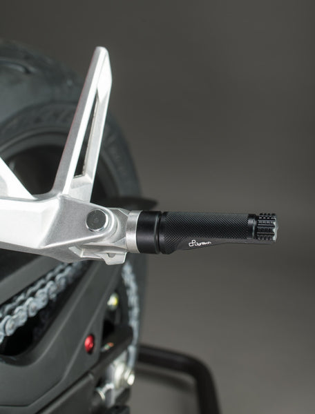 LighTech FTP100NER single footpeg installed, black left-side view; adapter, pin, original mounting bracket, motorcycle and other accessories are not included.