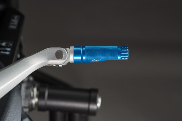 LighTech FTP100COB single footpeg installed, blue left-side view; adapter, pin, original mounting bracket, motorcycle and other accessories are not included.